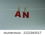 Small photo of Word 'AN' on white background. "An" is indefinite articles that precede nouns or the adjectives modifying nouns. Concept for art and education.