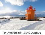 Beautiful yellow lighthouse, with the Atlantic surface as a background, Akureyri, Iceland .waves at the west coast of Iceland