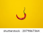 Calabrian red hot chilli pepper on a yellow background. Cool minimal flat lay, copy space
