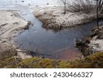 Small photo of a small river flows mightily to the sea after rain