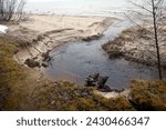 Small photo of a small river flows mightily to the sea after rain