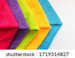 Close-up of five overlapping microfiber cleaning clothes of different colors