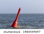 Small photo of Red spar buoy swims in the North Sea