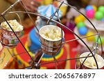 Small photo of KOLKATA, INDIA - Mar 21, 2021: Popcorn in a cardboard bin with red and white stripes on a roller costar Well decorated for weddings and party