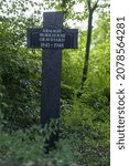 Small photo of ARMAGH, UNITED KINGDOM - Sep 26, 2021: A marker cross mentioning the place for the burial of Armagh's old workhouse poor people in UK