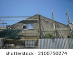 Small photo of A low angle shot of a building during renovation against a clea