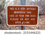 Small photo of PRESCOTT VALLEY, UNITED STATES - Apr 06, 2022: A SIgn warning about an unimproved trail, Wild Life Area Caution, Rattle Snakes at Fain Park in Prescott Valley, Arizona, USA