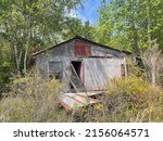 Small photo of Louisville, Ga USA - 04 11 22: Abandoned dilapidated building in the country tin shed
