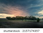 Small photo of A sunset in the summer sky over the fields with trees in Samso, Denmark