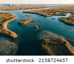 Small photo of An aerial view of the flowing water in grasslands in bright sunlight in Murrells Inlet, Georgetown county, South Carolina, United States