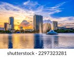 ORLANDO FL, US - May 24, 2022: Sunset and clouds over the Orlando skyline and fountain at Lake Eola Park, Orlando FL