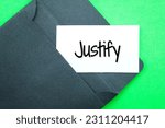 Small photo of black envelope and white paper with the word Justify. Business Concept