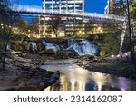 Small photo of A scenic view of Liberty Bridge and Reedy Falls in Greenville, South Carolina