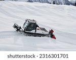 Small photo of BETTMERALP, CH - Jan 10, 2023: A snow vehicle going upslope in the Swiss Alps.