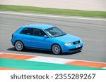 Small photo of VALENCIA, ES - Jun 05, 2022: first generation blue Audi A3 running on the Valencia racing circuit