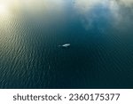 An aerial shot of a boat in the endless sea