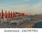 Small photo of The sunbeds at sunset on the beach of the Adriatic Sea in Lido di Spina, Italy.