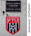 Small photo of FLINT, GB - Sep 16, 2023: Flint north wales football club building and team logo with entrance to bar