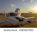 Small photo of CHICAGO, US - Apr 24, 2023: Cirrus SR20 parked on the ramp at Midway Field in Chicago. A 767 taking off in the background.