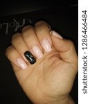 Small photo of Overnice female manicure in flesh-colour and bright accent in the form of black marble on the ring finger.