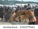 Small photo of Men from knightly and historical brotherhoods during the staging of the battle between Slavs and Vikings at the Slavs and Vikings Festival on Wolin Island in Poland