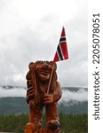Small photo of Hajjell, Norway - August 19 2017: a troll, a fairy-tale character from Norwegian legends; traditional norwegian troll figurine carved from wood, holding the norwegian flag