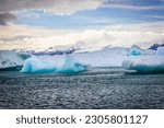 Big pieces of ice (floe) from glacier in the lake, ice islands, glacier and mountains, Jökulsárlón - Glacier Lagoon