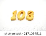 Small photo of Number 103 is made of gold-plated teak, 1 cm thick, laid on a white painted aerated brick floor, giving good 3D visibility.