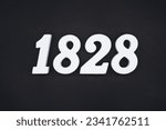 Small photo of Black for the background. The number 1828 is made of white painted wood.