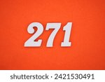 Small photo of Orange felt is the background. The numbers 271 are made from white painted wood.