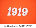 Small photo of Orange felt is the background. The numbers 1919 are made from white painted wood.