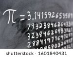 The number pi written with chalk on the blackboard, with its equivalence in numbers