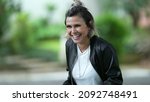 Small photo of Woman spontaneous real life laugh and smile outside. Person bursts laugh out loud