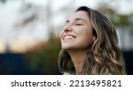 Small photo of Portrait of a grateful contemplative young woman closeup face. Meditative 20s girl opening eyes to sky with gratitude