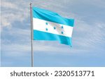 Small photo of The flag of Honduras consists of three equal horizontal stripes of turquoise, white and turquoise, with five turquoise stars in a quincuncial pattern at the centre of the middle stripe