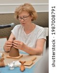 Small photo of MoscowRussia - 06072021: a master class on modeling Dymkovo toys at the Russian Academy of Arts. Master Tamara Vorozhtsova