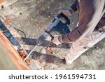 Small photo of Real construction worker working on a house renovation - authentic person on the job.