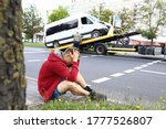 Man Sits On Side Of Road...