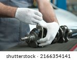 Small photo of Spare parts for a passenger car. The crankshaft. An auto mechanic measures the crankshaft crank neck with a micrometer. Car engine repair.