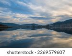 Different views of Golcuk Lake near to Izmir Province, beautiful reflection on water and colors of nature with clouds on blue sky