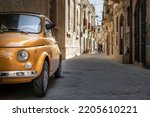 An old Fiat 500 in the old city centre of Syracuse, Sicily, Italy.
