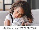 Small photo of Little small cute african daughter girl preteen child kid hugging embracing mother mom nanny childminder with love and care. Motherhood and adoption. Mother`s protection.