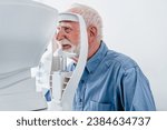 Small photo of Close up photo of a senior male patient undergoing vision examination. Myopia eyesight loss prevention. Cataract illness treatment with modern equipment