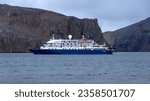 Small photo of Whaler's Bay, Deception Island, Antarctica - March 4, 2022: Expedition cruise ship moored in the bay