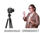 Angry woman teacher with camera on tripod leads online school on isolated on a white background, copy space