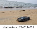 A car (blurred image) on beach at day time