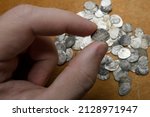 Small photo of A treasure trove of silver coins from the reign of Ivan 4 the Terrible. Medieval money of Russia in the hands of a collector. Study and attribution of coins. Numismatics, collecting.
