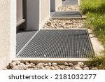 Small photo of Drain Mesh Entrance. Floor Drain Sysrem outdoor. Drain grates. Drainage Mesh in front of house entrance. Drain on Ground Floor. Drainage Grid. Selective focus