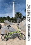 Small photo of Photo tittle : riding bike in beach; date taken : 3 March 2023; location : Belitung Island, bangka belitung province, Indonesia; description : a view beach in lengkuas island