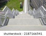 Stairway to footbridge or overpass divided into two sides for walking up and down, Stainless steel railing for people walk cross the road crossing safety.